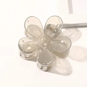 Macro detail of a translucent grey flower hair claw clip with a durable metal spring