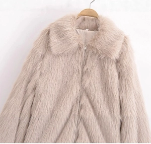Detail of fluffy faux fur jacket in apricot with silver zipper and large lapel collar