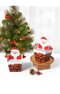 Detail of Santa climbing chimney gift boxes on a festive wooden stand with Christmas tree