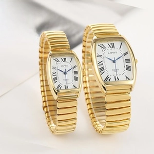 Detail view of gold quartz watches with tonneau cases and elastic bands for elderly