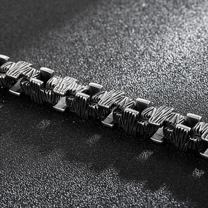 Macro shot of industrial steel chain link with rugged rock texture and matte finish