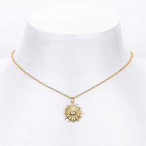Detail view of gold S925 sterling silver sunburst pendant necklace with white zircon