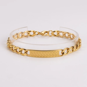 Macro view of gold stainless steel link bracelet with textured rectangular bar detail