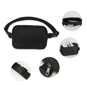 Detail view of black nylon waist bag with adjustable strap and multiple zipper compartments