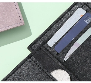 Close-up of black PU leather wallet card slots with coins and blue card display