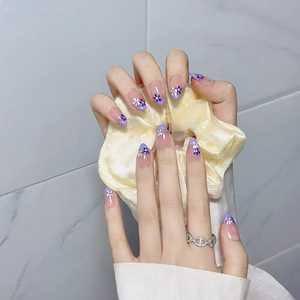 Violet French press-on nails with white flower patterns and elegant oval shape