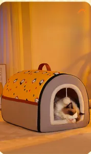 Close-up of a warm semi-enclosed pet house with soft plush edges and a hanging toy ball