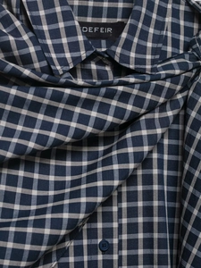 Detailed view of plaid shirt collar with blue white check pattern and fine cotton texture