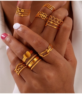 Close-up of gold ring set featuring heart, geometric hollows and chain textures