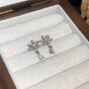 Close-up of 18k gold plated snowflake drop earrings with sparkling zircon stones