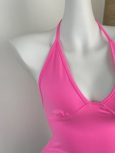 Detailed view of the vibrant pink halter neck crop top with fine knitted texture details