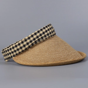 Close-up of woven straw sun visor with stylish black and yellow checkered fabric trim