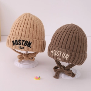 Detail of ribbed knit children's BOSTON beanies with adjustable chin straps in brown tones