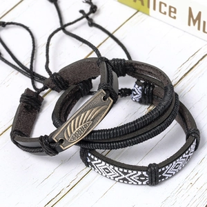 Detail view of retro multilayer leather bracelets with bronze feather charm and woven patterns