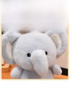 Macro shot of light blue elephant plush toy showing soft fabric texture and ear details