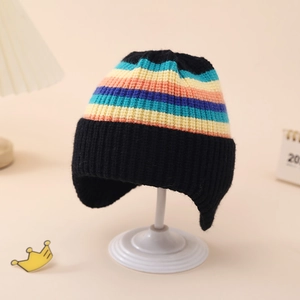 Detailed close-up of a rainbow striped black knit baby hat with ear flaps for winter warmth