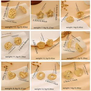 Macro view of gold metal earrings with textured hearts and flowers arranged in a grid
