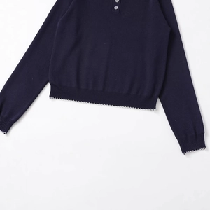 Dark blue long sleeve knit polo sweater featuring white scalloped edges and button collar