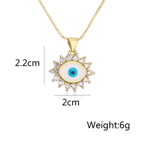 Detail view showing a 2.2cm evil eye pendant with blue enamel and sparkling cubic zirconia