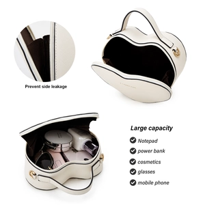 Detail view of heart-shaped white cosmetic bag showing large capacity and side-leakage prevention