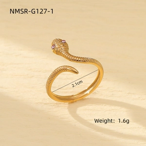 Detailed close-up of a golden snake ring with pink zircon eyes and scale textures