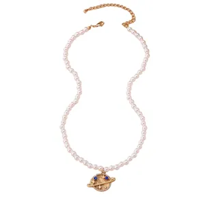 Elegant pearl necklace with golden Saturn planet pendant and sparkling crystals