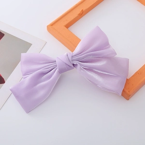 Detail of light purple organza bow hair clip with a pearlescent satin finish