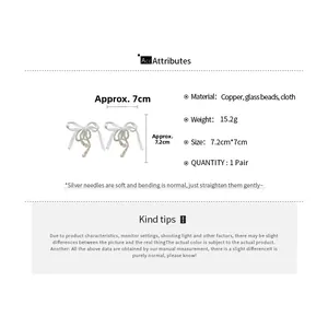 Detailed spec sheet showing white fabric bow earrings with glass beads and size info
