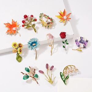 Handcrafted floral enamel brooch set featuring daisy, sunflower and maple leaf designs