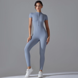 Detail view of the zipper neckline and elastic fabric on this blue yoga bodysuit