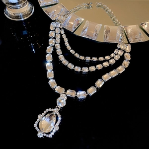 Macro shot of triple-layer rectangle crystal necklace with a large teardrop pendant detail