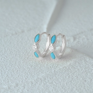 Macro detail of S925 silver hoop earrings with marquise turquoise and round zircon stones