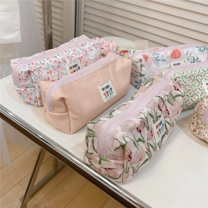 Close-up of floral print cotton pencil case and makeup bag with smooth metal zipper