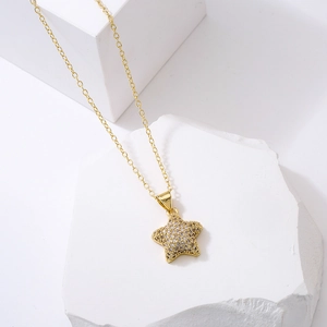 Elegant 18K gold plated star pendant necklace with cubic zirconia on white stone