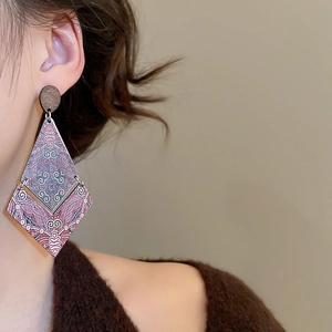 Detail of ethnic geometric diamond wood dangle earrings with colorful totem print