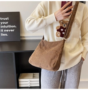 Detail view of brown corduroy crossbody bag showing soft texture and premium fabric finish