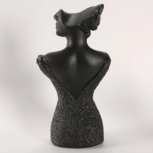 Detail of a matte black resin female bust stand for necklace and earring display