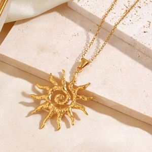 Minimalist gold sun pendant necklace with spiral center and hammered texture design