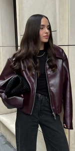 Close-up of deep burgundy faux leather jacket with turn-down collar and metallic zipper