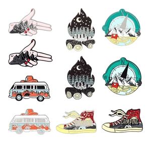 Outdoor camping enamel pin set featuring compass, campfire, RV, and hiking shoe designs