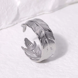 Anello aperto a piuma in argento acciaio inox con trama su pietra bianca sfondo