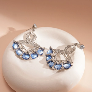 Vintage silver earrings with blue gemstones and diamonds in geometric fan design