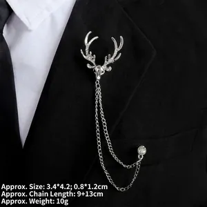 Detail of silver stag brooch with rhinestones and chains on a black suit lapel