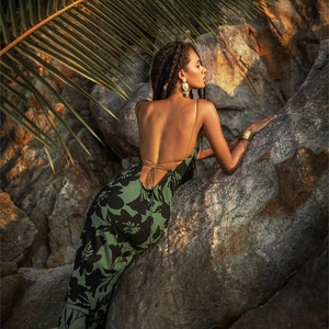 Detail of green floral backless maxi dress with cross tie-up straps and open back cutout