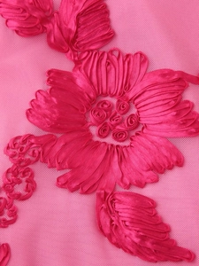 Macro detail of elegant pink floral 3D embroidery on breathable mesh dress fabric
