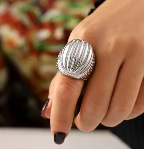 Macro detail of vintage silver oval ring featuring vertical ridges and textured hammered dots