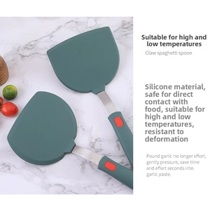 Detail of dark green food-grade silicone spatula with durable stainless steel handle