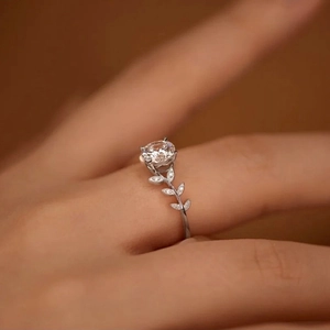Close-up of laurel branch silver ring with round sparkling stone and leaf detailing