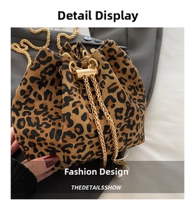 Detailed top view of a leopard print bucket bag with golden chain drawstring closure