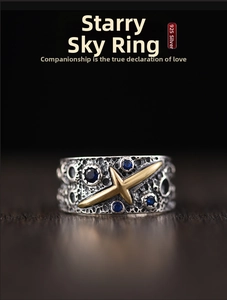 Detail of 925 silver starry sky ring with meteorite texture and golden star motif